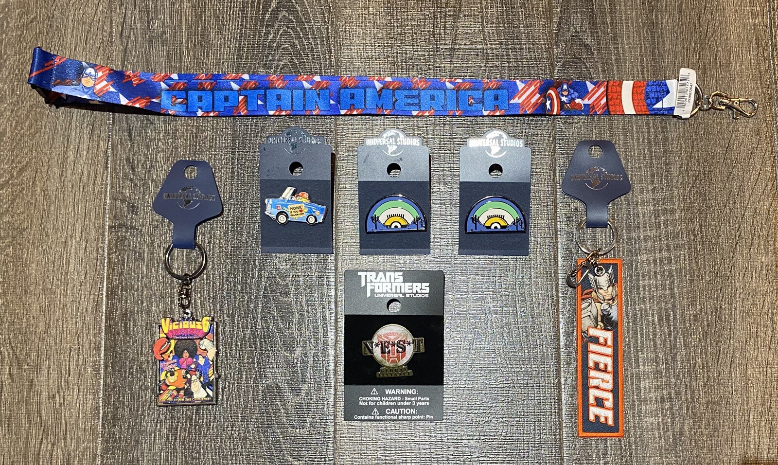 Lot of 7 Universal Items: 4 Pins & 2 Keychains & Card Case Holder #014